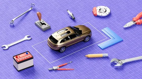 A model car surrounded by tools on a workbench