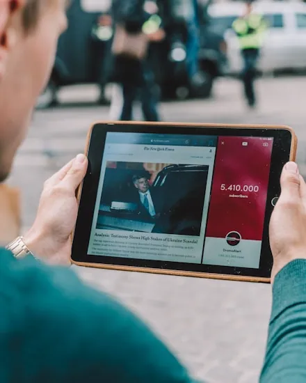 A buyer comparing vehicle listings on a tablet